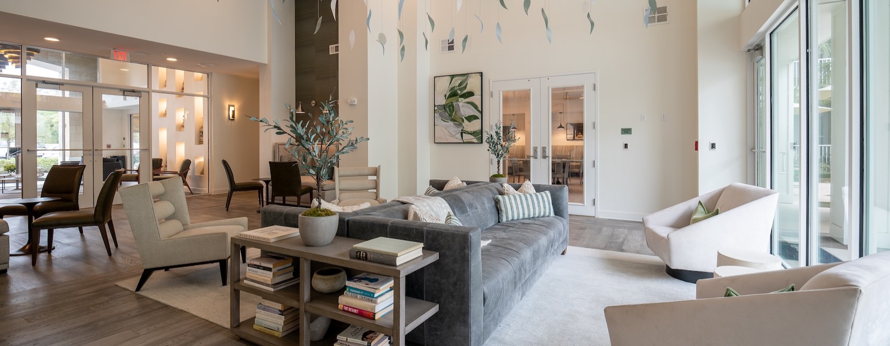 a room with a couch, tables and chairs