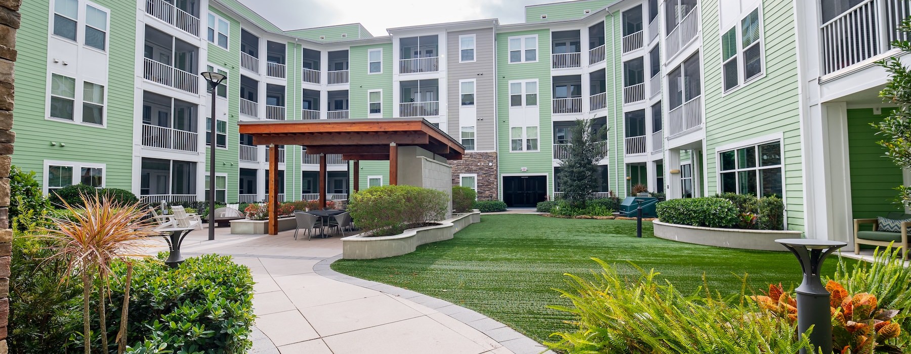 a courtyard with a path and grass