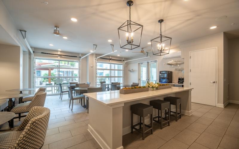 a kitchen with a bar and chairs